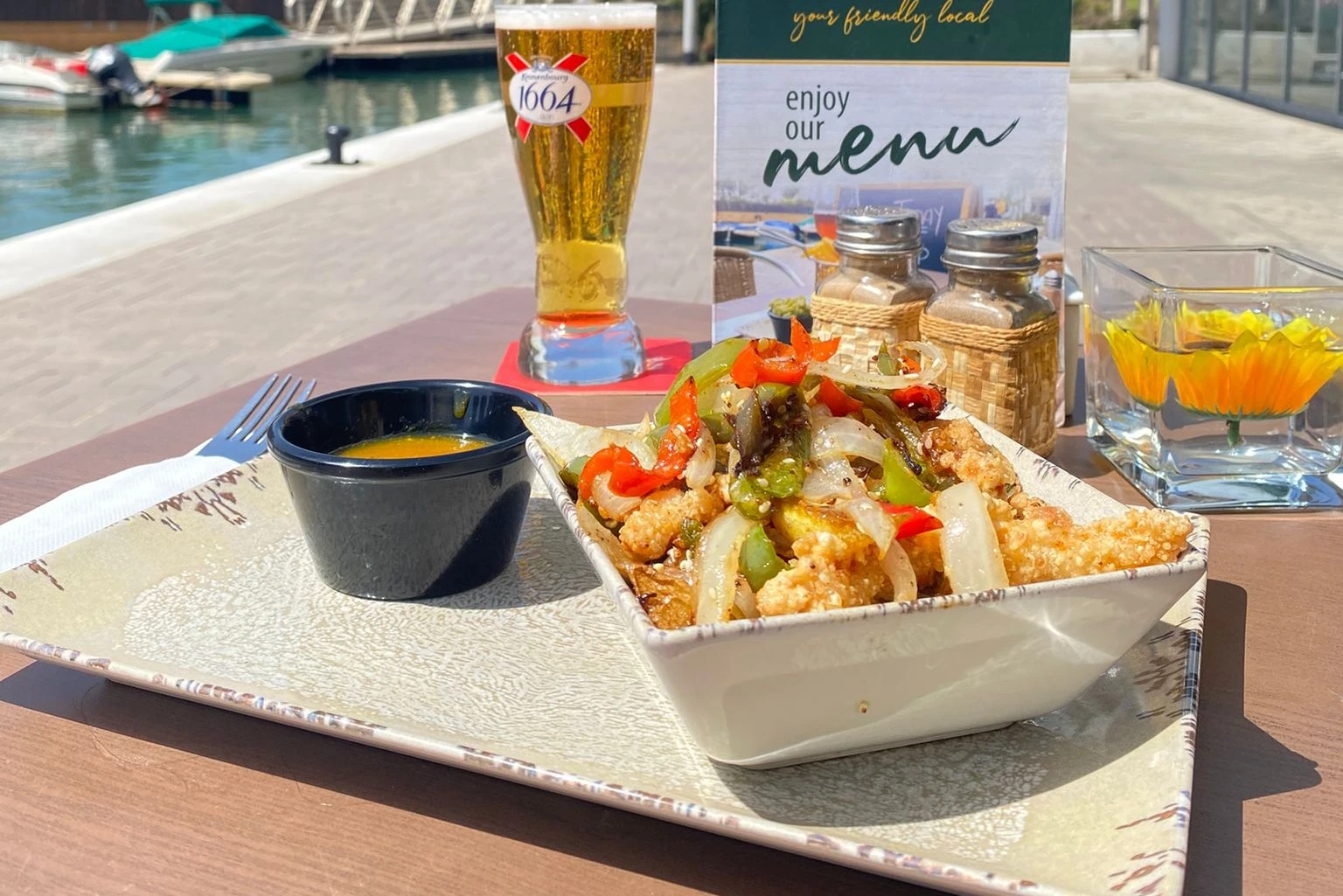 Salt and pepper dish with a pint of beer